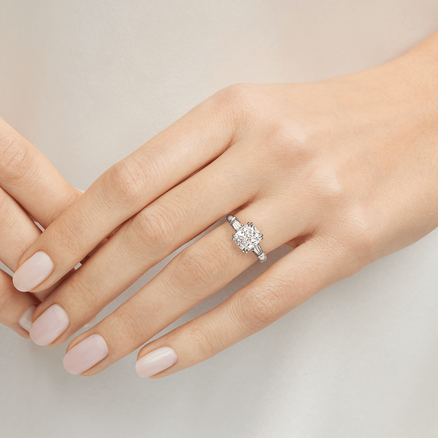 Classic Winston Cushion-Cut Engagement Ring with Tapered Baguette Side Stones featured on a model