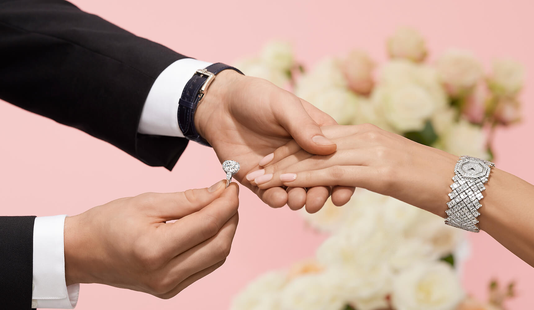 Male placing Diamond Engagement Ring on female hand